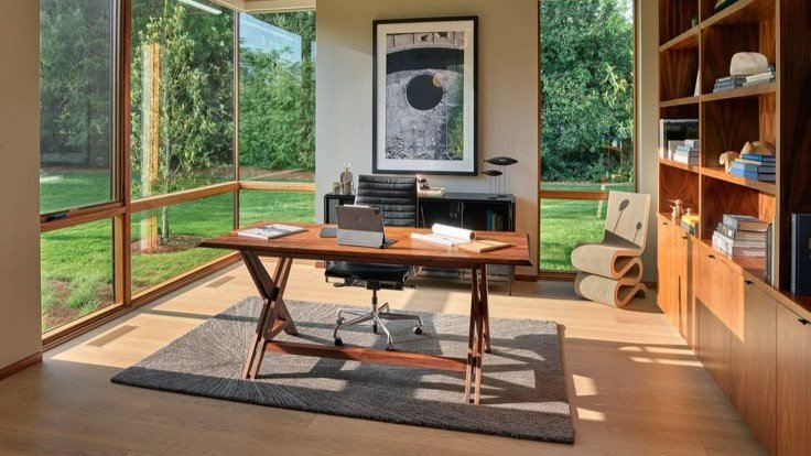Minimalist home office corner with window light